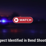 Fostoria News Police car with flashing lights at night during Bend school shooting.